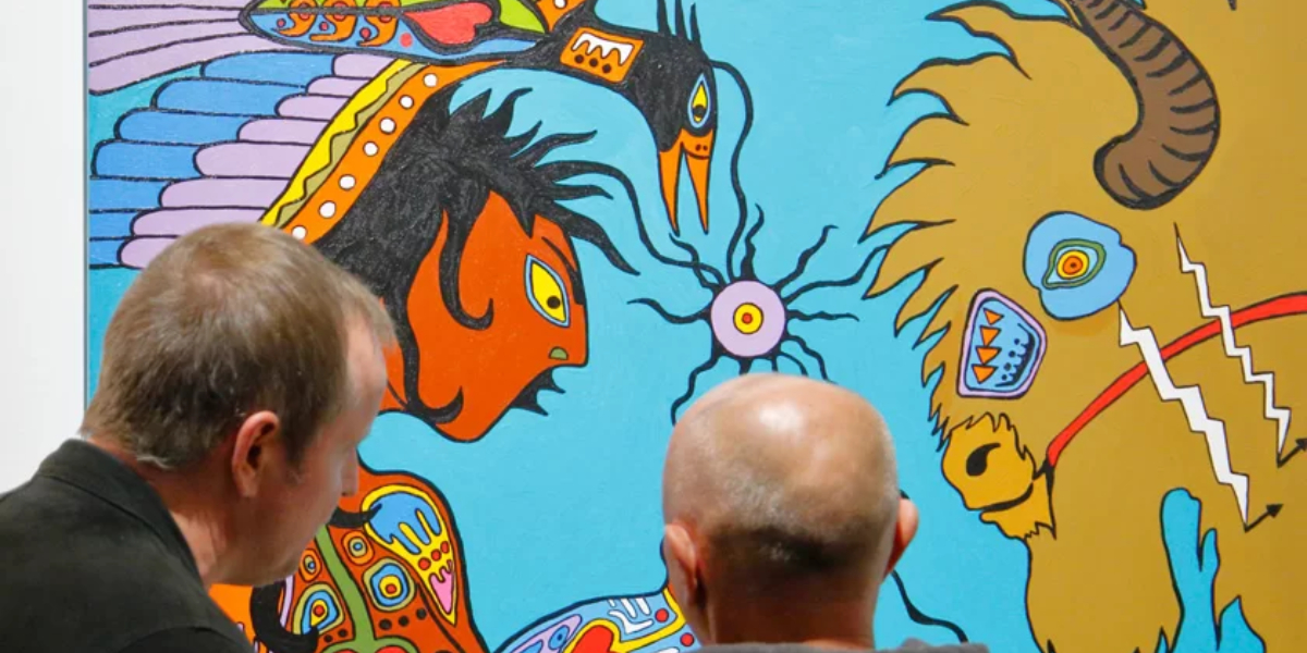 two people looking at art on a wall